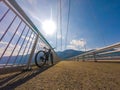 Theme of mountain biking in Scandinavia. human tourist in helmet and sportswear on bicycle in Norway on Hardanger Bridge Royalty Free Stock Photo