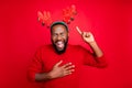 Theme party concept. Portrait of funky man with black beard pointing at his deer costume laugh at childish appearance Royalty Free Stock Photo