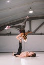 Theme sport and a healthy lifestyle. Acrobatics and acroyoga. Young sporty couple practicing acroyoga handstand. Male and female Royalty Free Stock Photo
