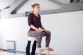 Theme sports health acrobatic yoga. A pair of two young Caucasian girls in the gym doing a base posture chair. Physical and Royalty Free Stock Photo