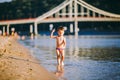 Theme summer outdoor activities near the river on the city beach in Kiev Ukraine. Little funny baby boy running along the river Royalty Free Stock Photo