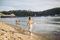 Theme summer outdoor activities near the river on the city beach in Kiev Ukraine. Little funny baby boy running along the river Royalty Free Stock Photo