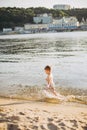 Theme summer outdoor activities near the river on the city beach in Kiev Ukraine. Little funny baby boy running along the river Royalty Free Stock Photo