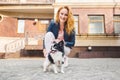 Theme walk with pet. Caucasian young woman and chihuahua dog on a leash in two of a european old house. dog chihuahua with her Royalty Free Stock Photo