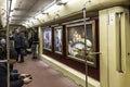 Themed interior of the vagon of the Moscow underground, decorated with pictures by famous Russian artist Sergey Andriyaka and his