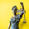 Themis Greek goddess of justice on yellow background Royalty Free Stock Photo