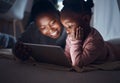 And then they lived happily ever after. a mother reading bedtime stories with her daughter on a digital tablet. Royalty Free Stock Photo