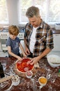 Then you add your meat...a father and his son making pizza at home. Royalty Free Stock Photo