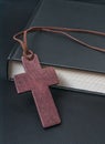 Theology concept. Wooden cross next to Holy Bible