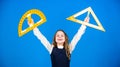 Theorems and axioms. Smart and clever concept. Girl with big ruler. School student study geometry. Kid school uniform Royalty Free Stock Photo