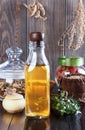 Therapeutic herbal tincture, alternative medicine, love potions, dried herbs on a wooden table.