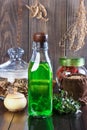 Therapeutic herbal tincture, alternative medicine, love potions, dried herbs on a wooden table.