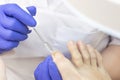 Therapeutic pedicure. the pedicure master applies a softening oil or a medicinal product pipette to the nails