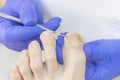 Therapeutic pedicure. Master podologist does hardware pedicure. visit to the podiatry. Foot treatment in the spa. Royalty Free Stock Photo