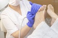 Therapeutic pedicure. Master podologist does hardware pedicure. visit to the podiatry. Foot treatment in the spa. Royalty Free Stock Photo