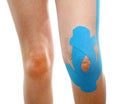 Therapeutic treatment of leg with blue physio tape