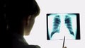 Therapist analyzing pneumonia lungs x-ray image, making conclusions, healthcare