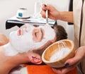 Therapist applying a face mask to a beautiful younga spa Royalty Free Stock Photo