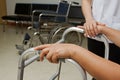 Therapist assisting disabled senior patient to walk