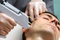 .Therapist doing facial mesotherapy treatment on middle aged man