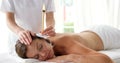 Therapist ear candling her patient