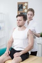 Therapist examining athletic man