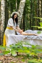 Therapist female doctor making woman relaxing spa face massage with hands outdoors in the forest Royalty Free Stock Photo