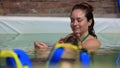 Therapist giving neck massage to man in pool