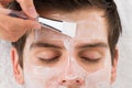 Therapist Applying Face Mask To Man Royalty Free Stock Photo