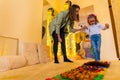 Therapist helping a young child living with cerebral palsy successfully improve her walking ability during therapy session. Royalty Free Stock Photo