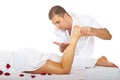 Therapist man massaging woman's leg