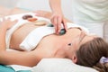 Therapist placing stones on woman`s body