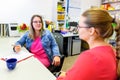 Therapist talking to a young mother after assessing her daughter in complex needs child therapy session. Royalty Free Stock Photo