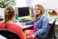 Therapist talking to a young mother after assessing her daughter in complex needs child therapy session. Royalty Free Stock Photo