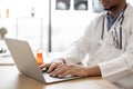 Therapist typing on computer in health center interior Royalty Free Stock Photo