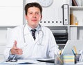 Therapist in uniform filling up documents Royalty Free Stock Photo