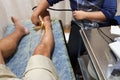 Therapist using ultrasound part of physiotheraphy treatment on swollen ankle Royalty Free Stock Photo
