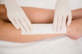 Therapist waxing womans leg at spa center Royalty Free Stock Photo