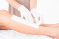 Therapist waxing womans leg at spa center Royalty Free Stock Photo