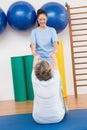 Therapist working with senior woman on exercise mat Royalty Free Stock Photo