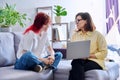 Therapy session for teenage girl, psychologist and patient together in office