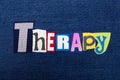 THERAPY text word collage, colorful fabric on blue denim, addiction and recovery concept Royalty Free Stock Photo