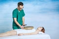 The therapy of a woman with a tambourine. Male masseur does nontraditional methods of medicine. Beautiful relaxed face