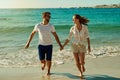 Is there any season more fun than summer. a happy young couple running along the beach. Royalty Free Stock Photo