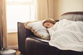 Is there anything better than a lazy afternoon nap. Shot of a young woman sleeping peacefully on the sofa at home. Royalty Free Stock Photo