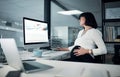 Is there anything else I need to add. an attractive pregnant businesswoman sitting in her office and using her computer Royalty Free Stock Photo