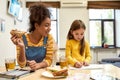 Always there for baby care. African american woman baby sitter entertaining caucasian cute little girl. Kid is drawing Royalty Free Stock Photo