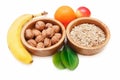 There are Banana,ApÃÂ·le,Orange with Walnuts in the Wooden Plate and Rolled Oats,with Green Leaves,Healthy Fresh Organic Food