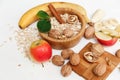 There are Banana,Apple,Walnuts in the Wooden Plate an