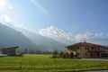 There is a barn near the village cottage. Mountains in the background. Picturesque nature and architecture outside the city Royalty Free Stock Photo